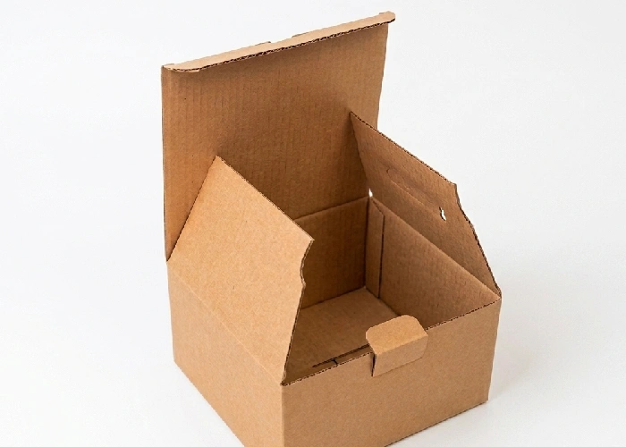 A pristine, empty compact parcel box resting open on a crisp white studio background.