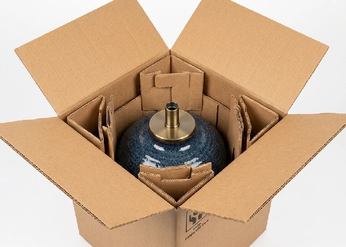 A heavy ceramic lamp base positioned next to reinforced corrugated inserts for secure anchoring.